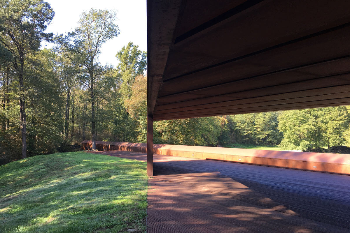 Corten steel pavilion creating a large window toward oak forest, featured on architecture tour RCR