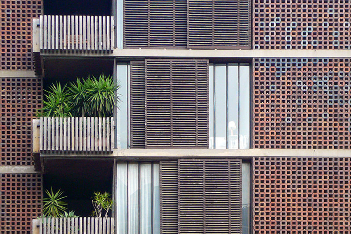 Detail of ceramic latticework in residential building facade, featured on architecture tour Modern Classics