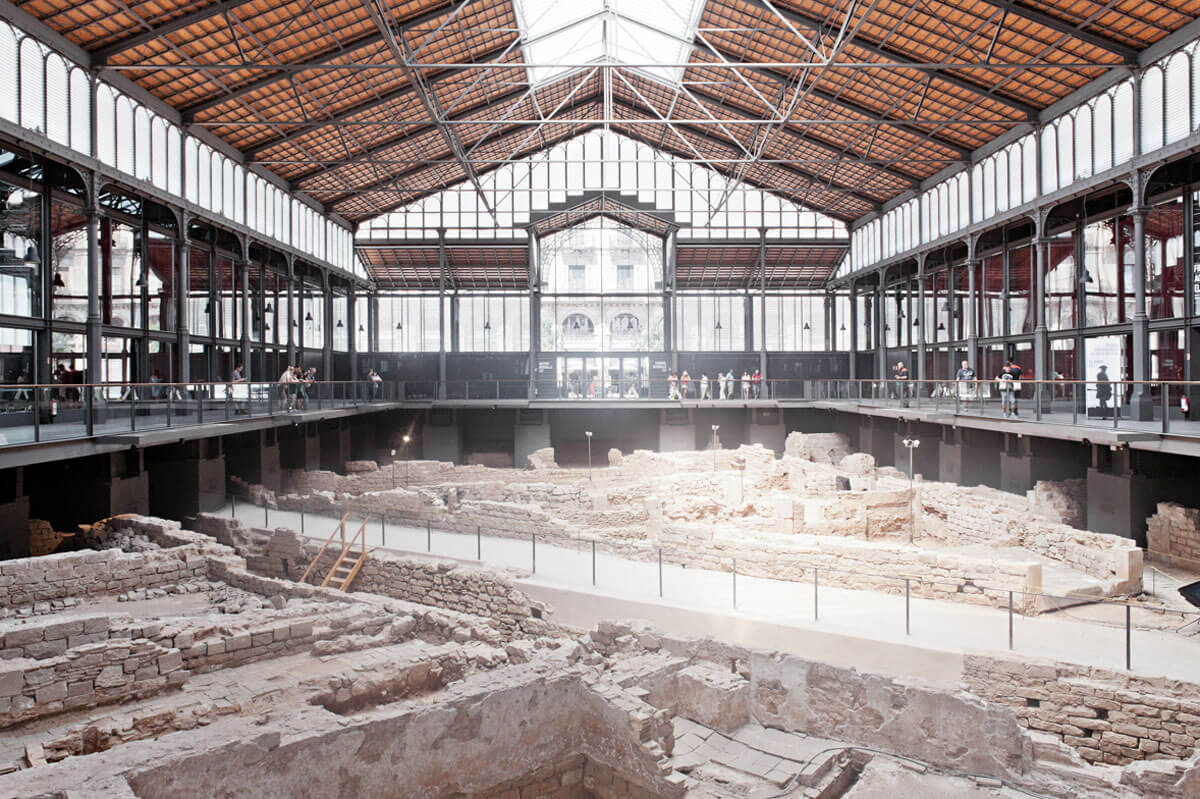 Archaeological remains staged inside a former market hall, with viewing platform at street level