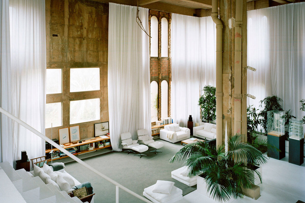 Interior of Ricardo Bofill`s studio in a former cement factory, with contrasting white furniture