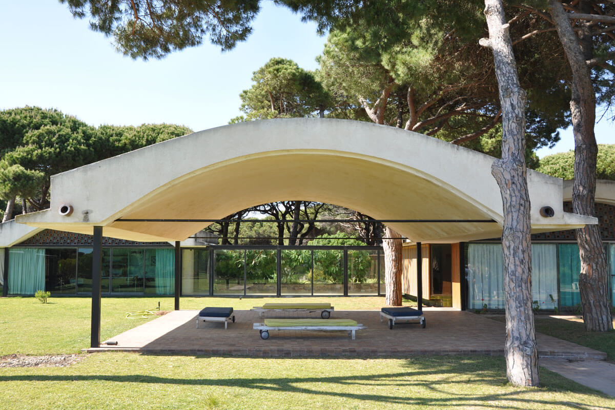 Vaulted ceiling of Barcelona's Gomis house covering a terrace surrounded by pine trees