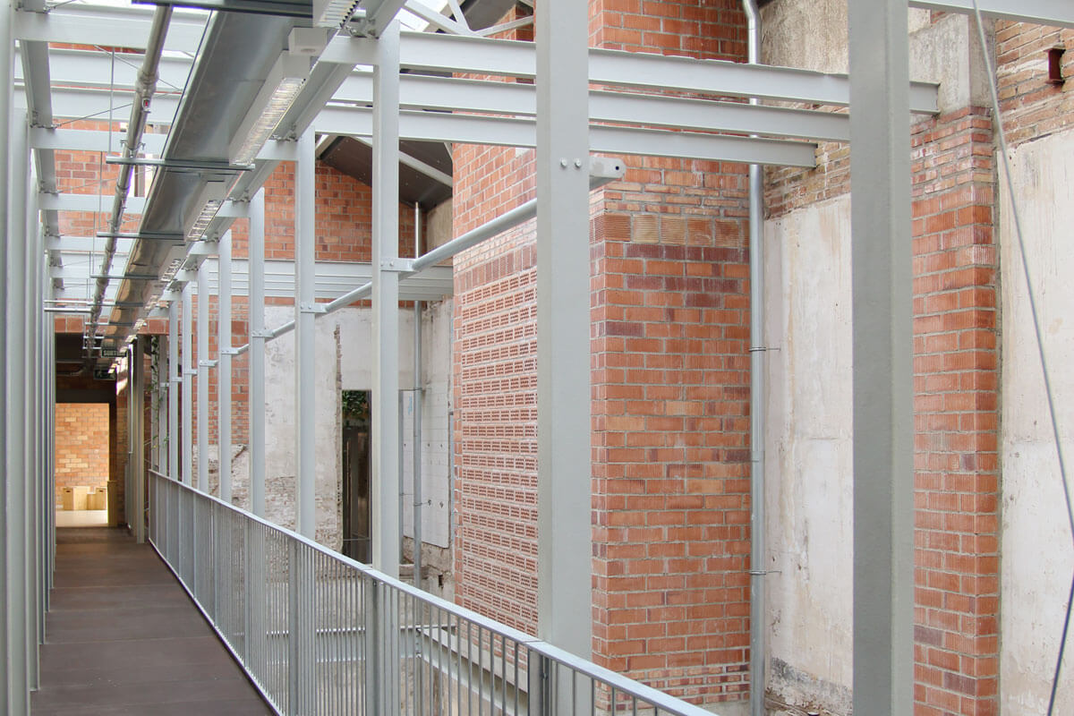 Horizontal circulation in restored brickwork building Lleialtat Santsenca, featured on architecture tour Sustainability