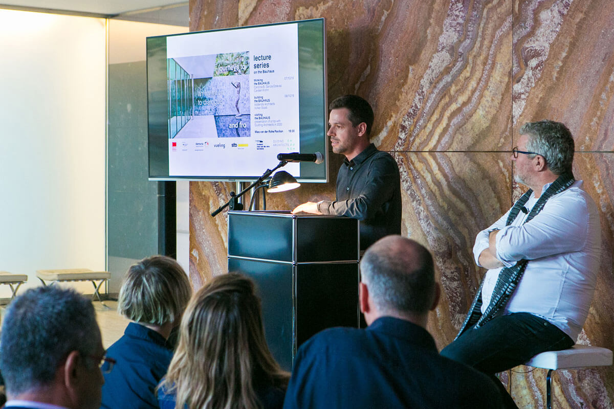 Architect Lorenzo Karasz giving a lecture in front of audience in Barcelona pavilion