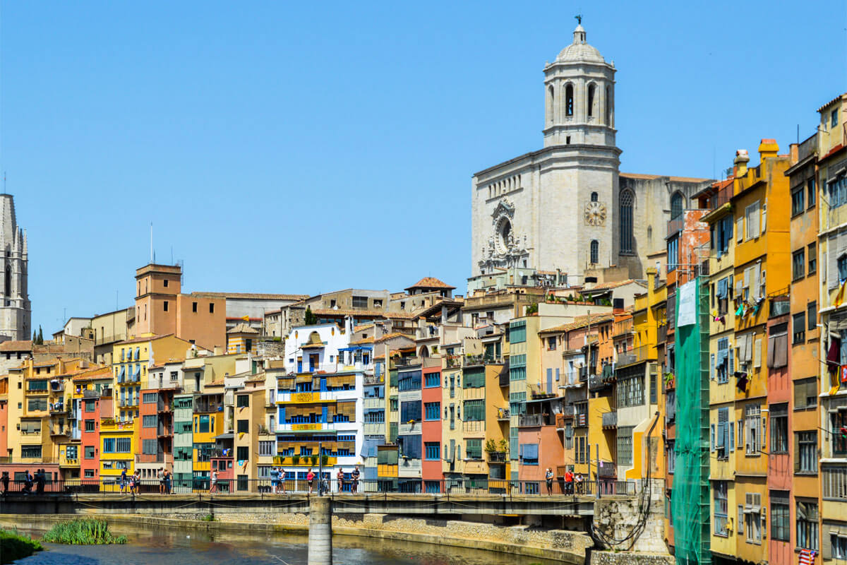 Coloured houses overlooking the Onyar river, with Girona Cathedral in the background