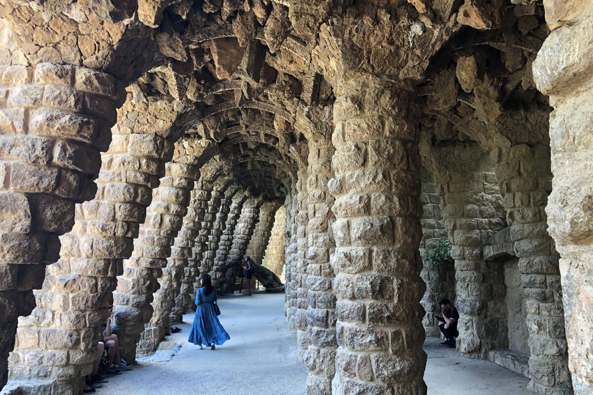 Arching tree-like columns made of stone in Gaudí's Park Güell