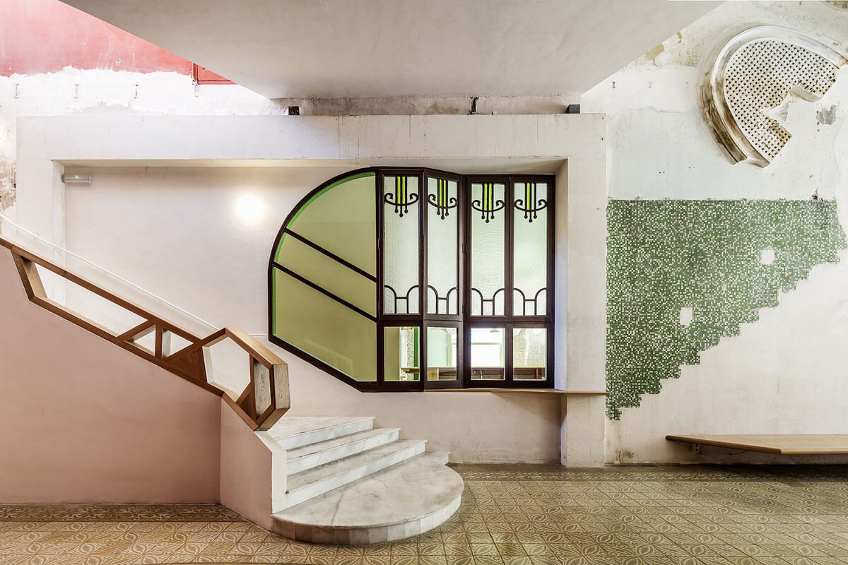 Vestibule of Barcelona's Sala Beckett with original decorative elements, featured on architecture tour Industrial Heritage