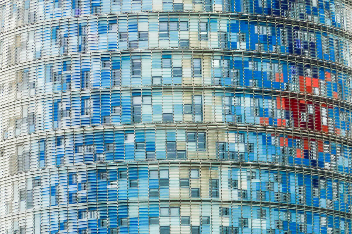 Close-up view of Torre Glòries' iridescent facade of coloured aluminium sheeting and glass louvres