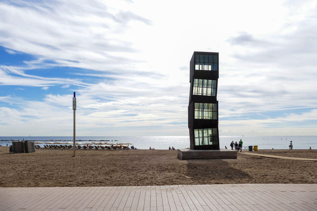 Beachside sculpture by Rebecca Horn consisting of four stacked iron boxes, featured on architecture tour Seafront
