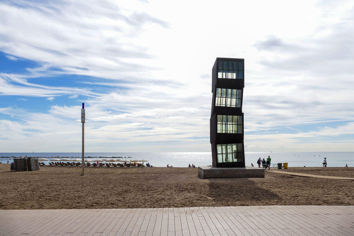 Beachside sculpture by Rebecca Horn consisting of four stacked iron boxes, featured on architecture tour Seafront